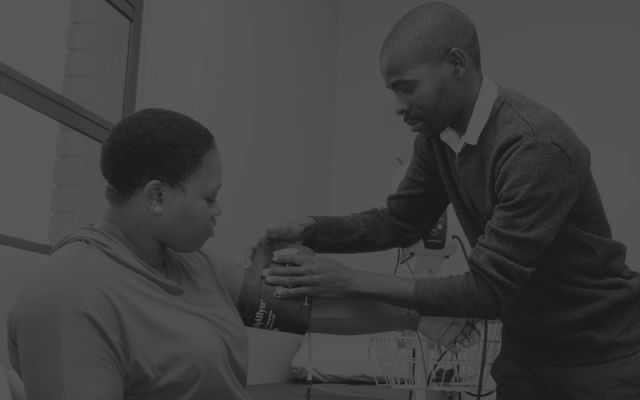 A medical personnel taking blood pressure