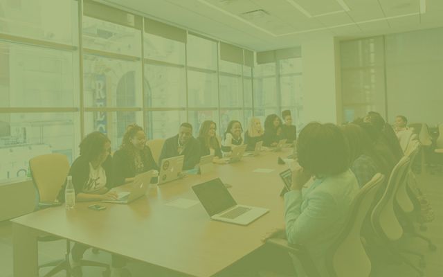 people meeting in a large conference room